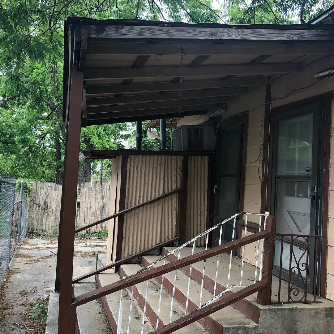 a small house with a porch and stairs