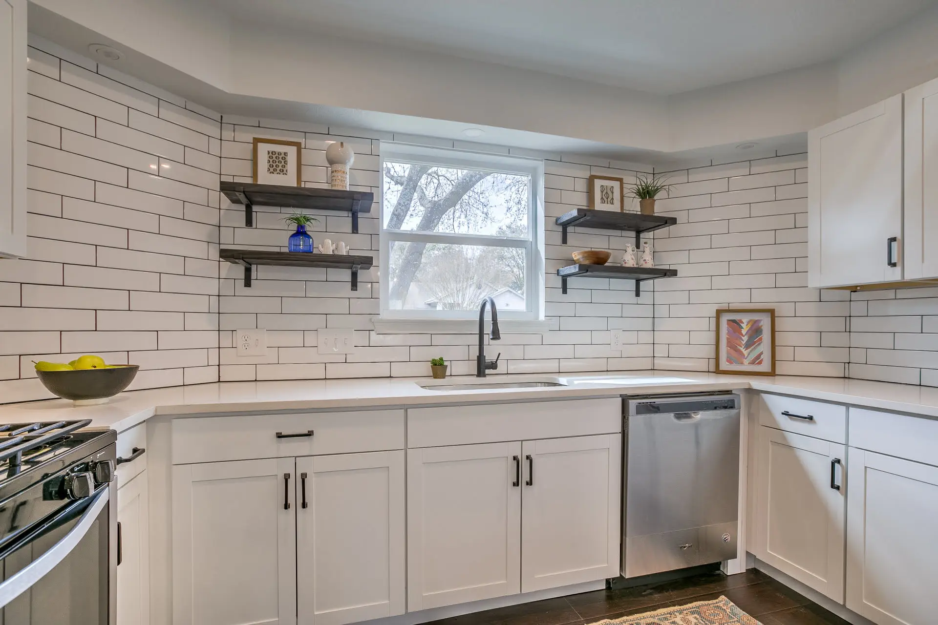 a kitchen with white cabinets and a dishwasher
