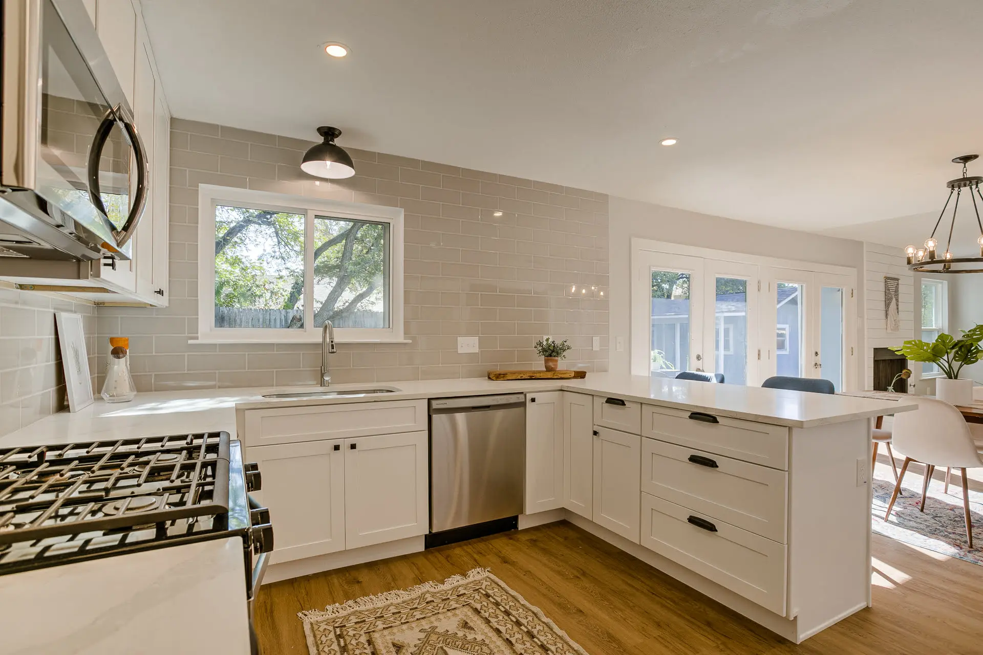 a kitchen with a stove top oven sitting next to a dining room table