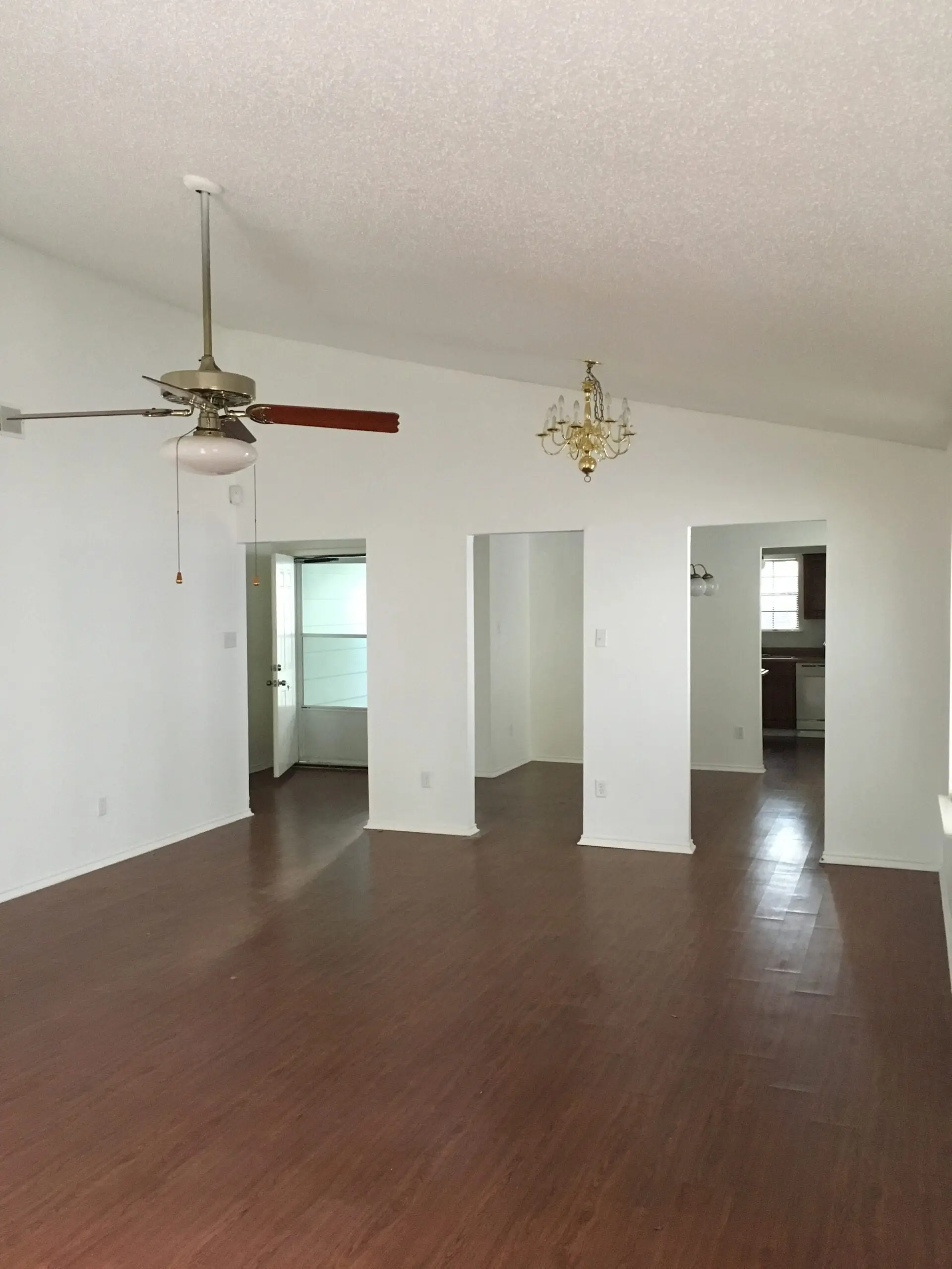 a living room with hard wood floors and a ceiling fan