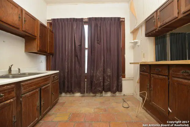 a kitchen with wooden cabinets and a window