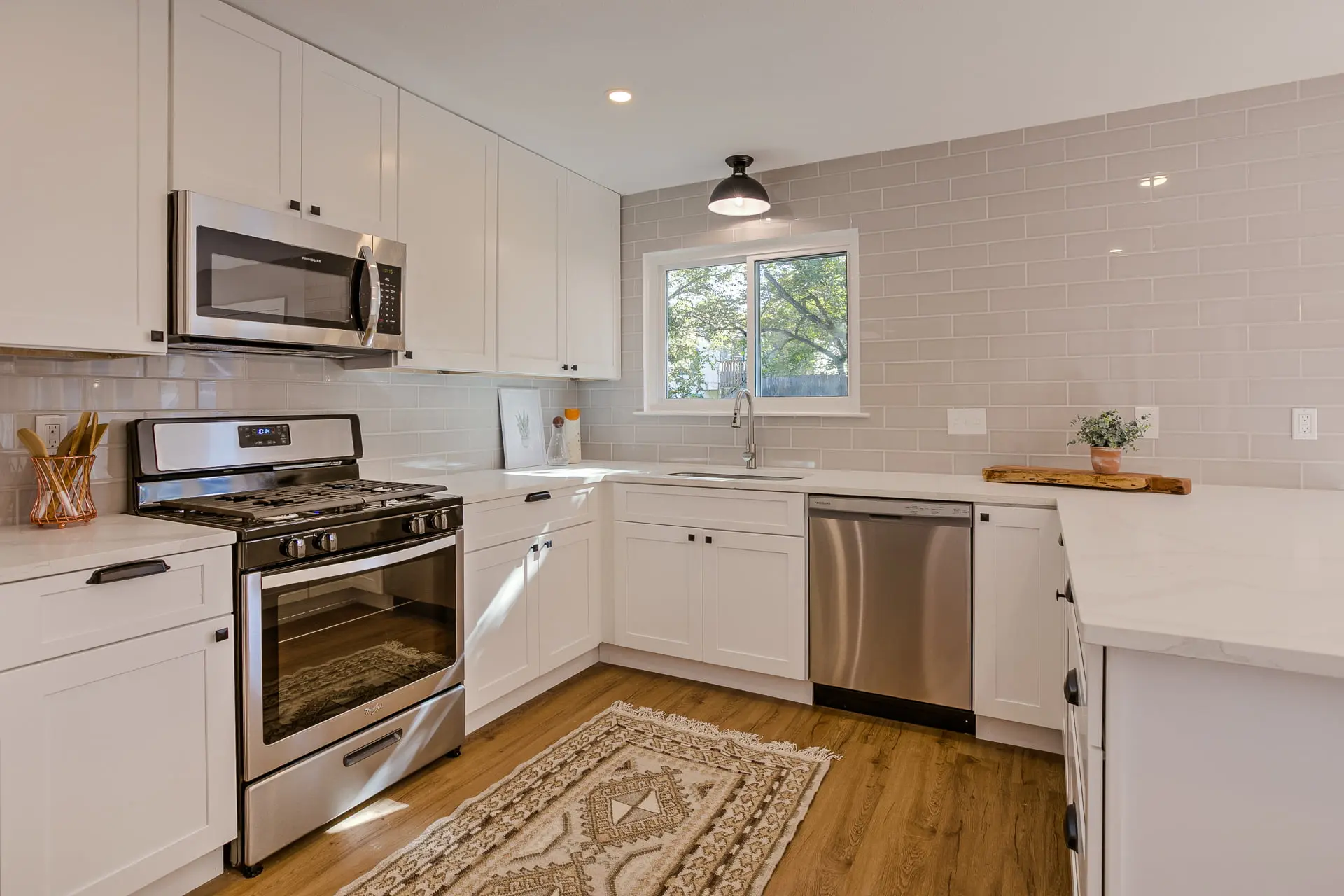 a kitchen with white cabinets and stainless steel appliances