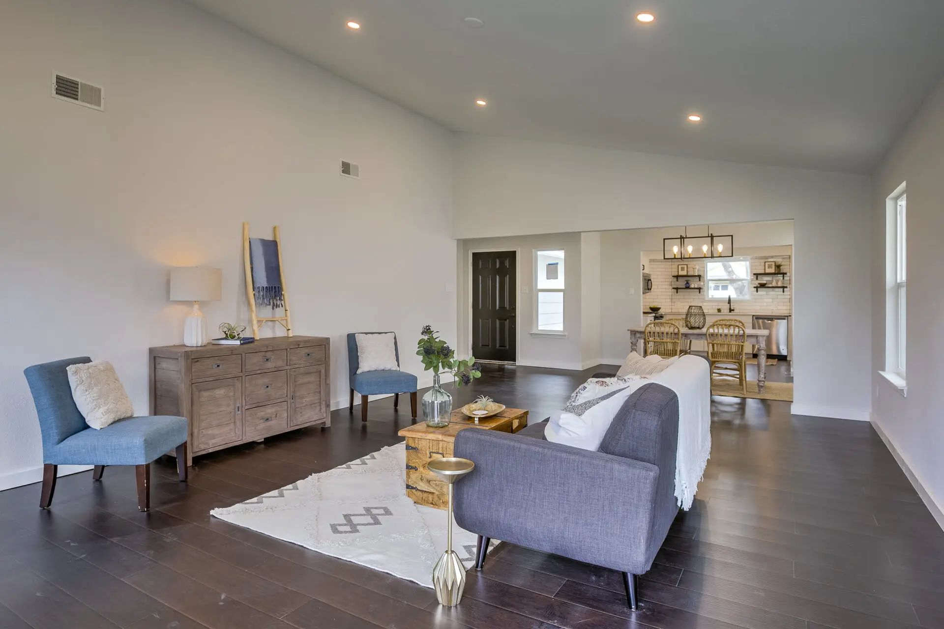 a living room filled with furniture and a large window