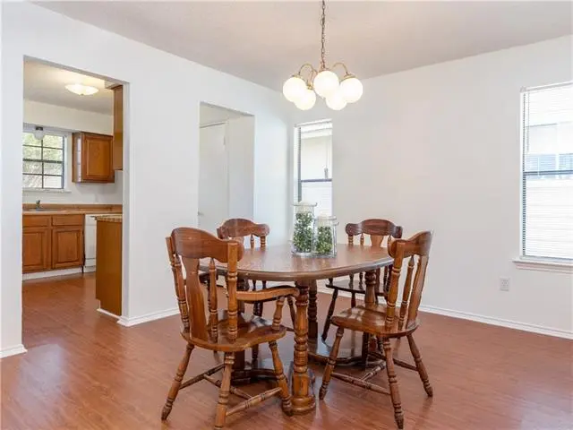 a dining room with a table and chairs