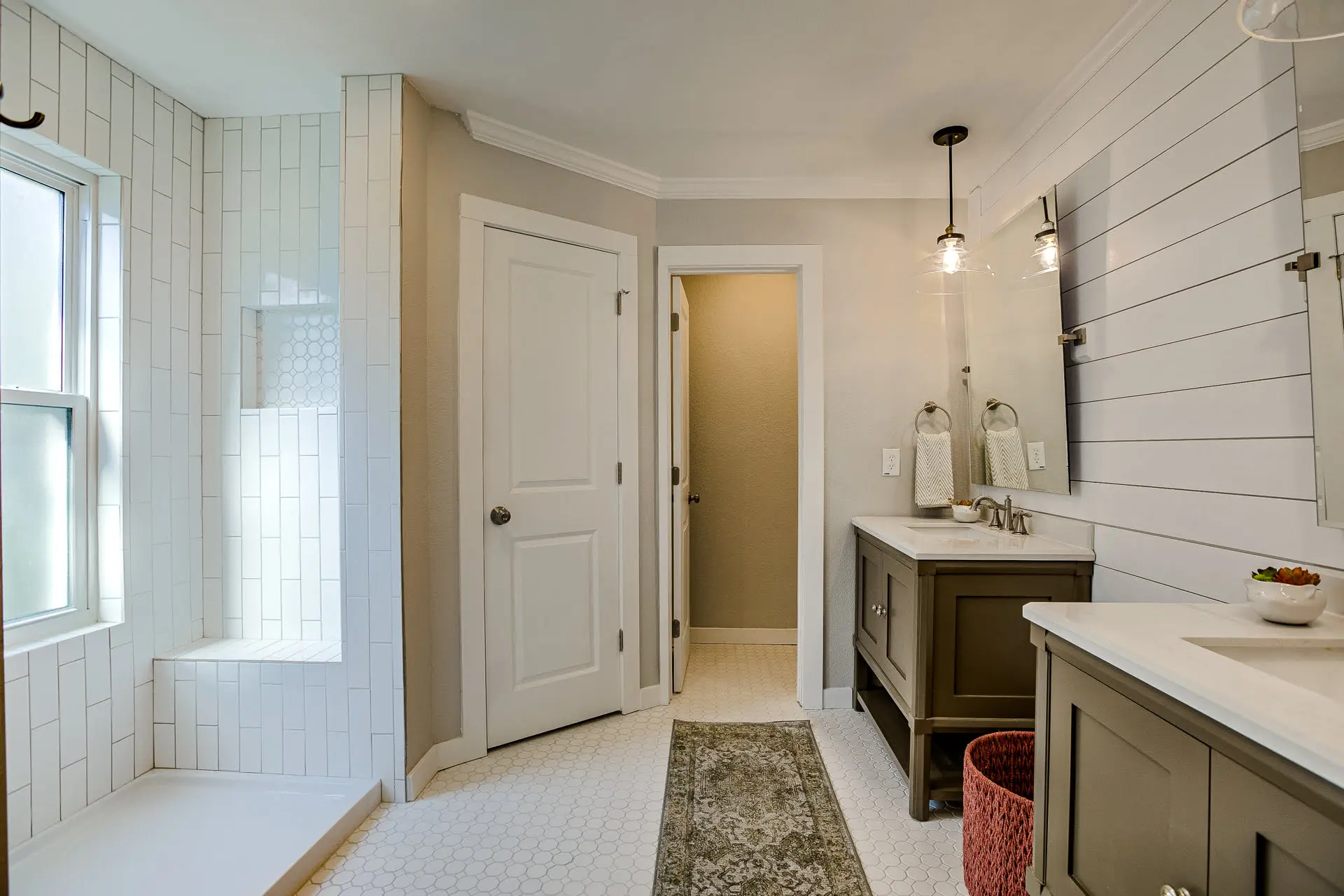 a bathroom with a sink, mirror, and bathtub