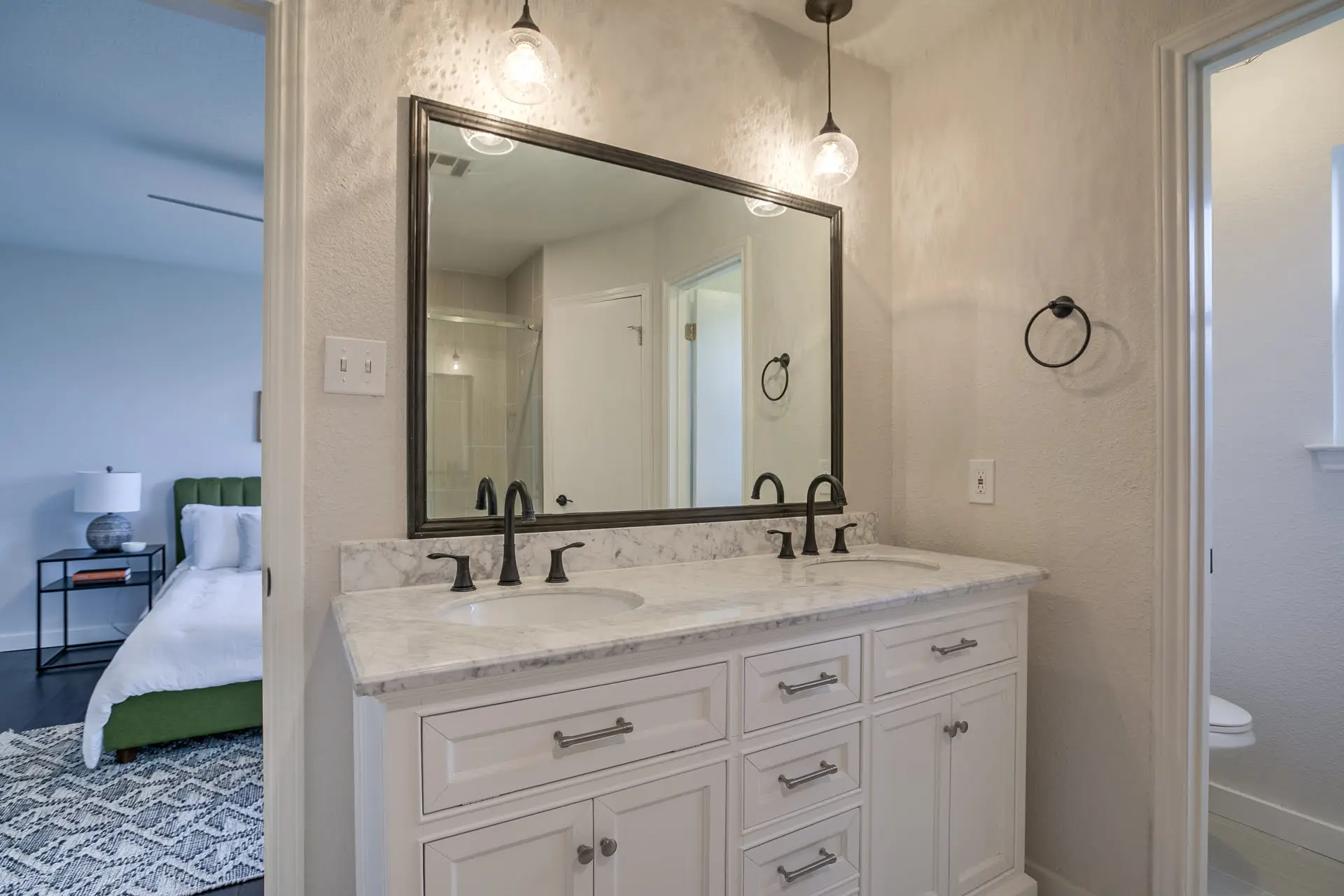 a bathroom with double sinks and a large mirror