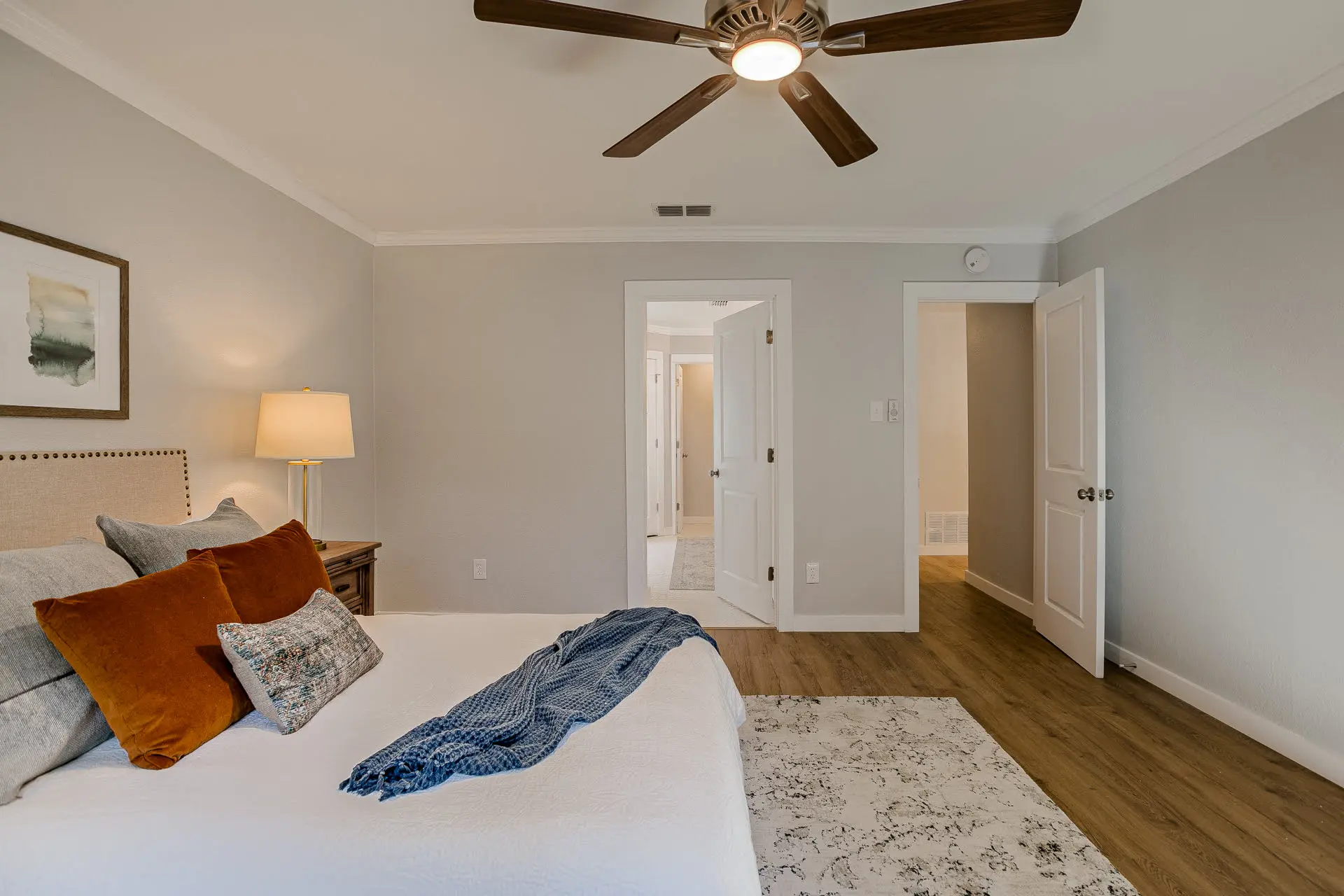 a bedroom with a ceiling fan and a bed