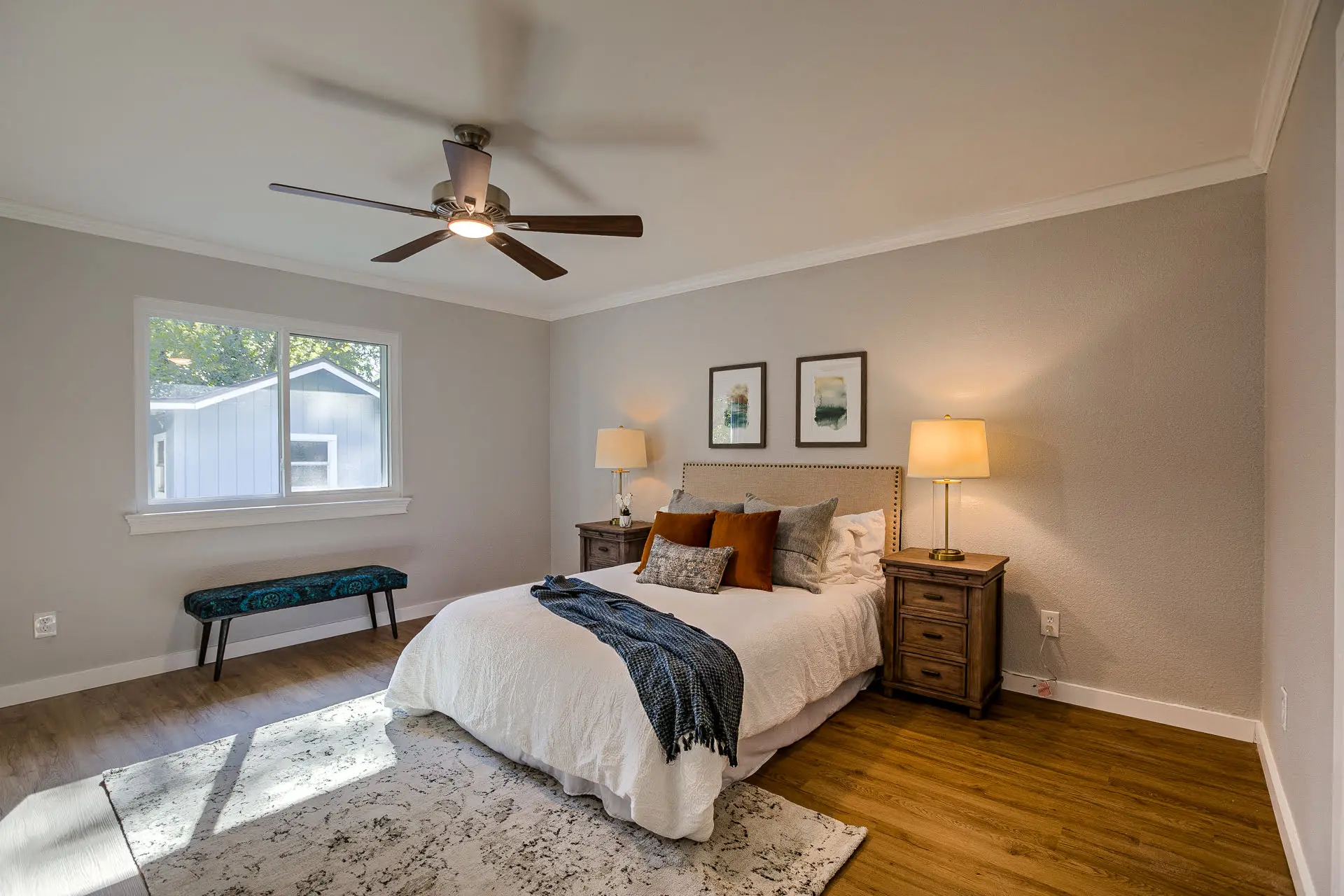 a bedroom with a large bed and a ceiling fan