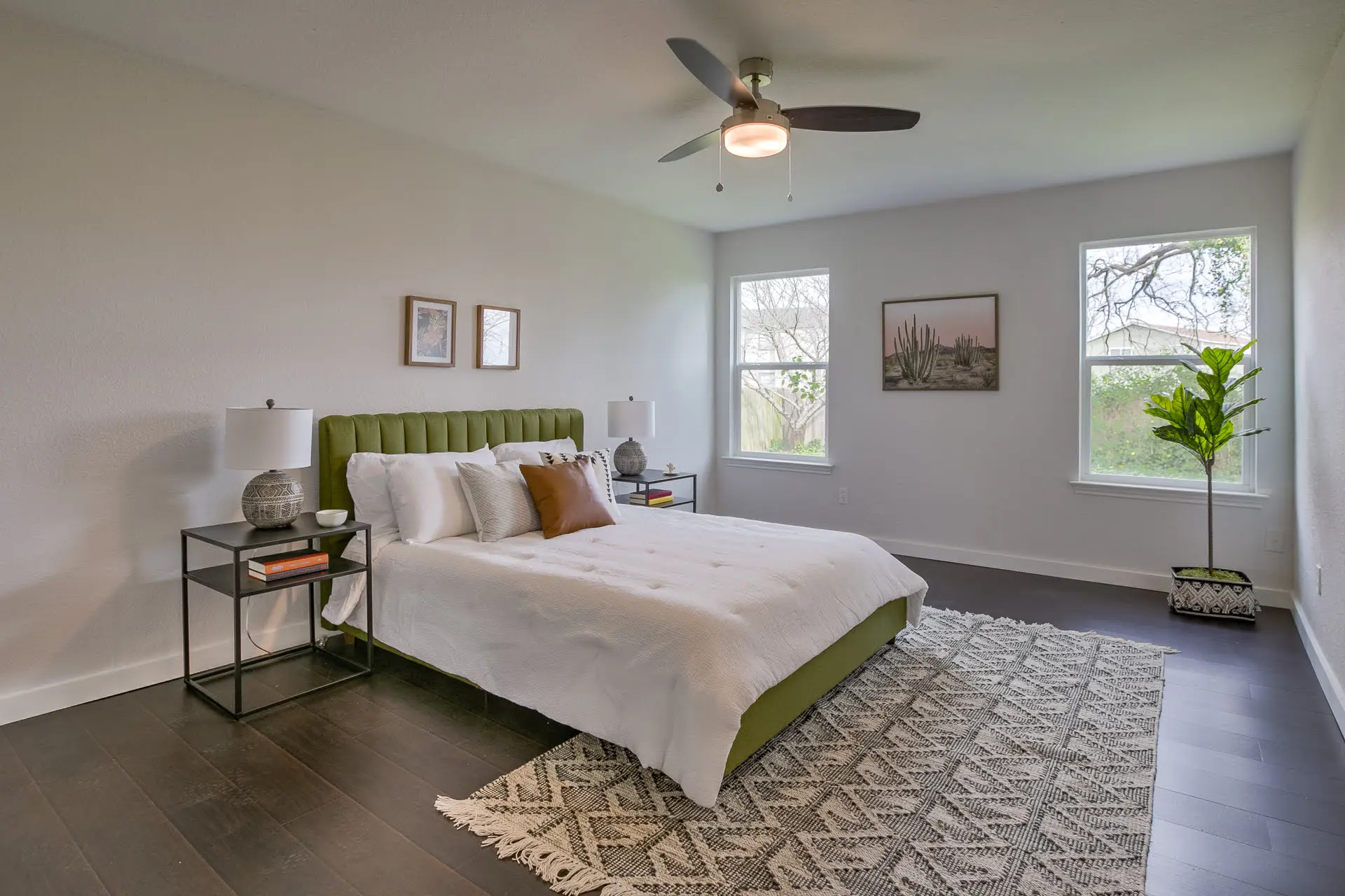 a bedroom with a large bed and a ceiling fan