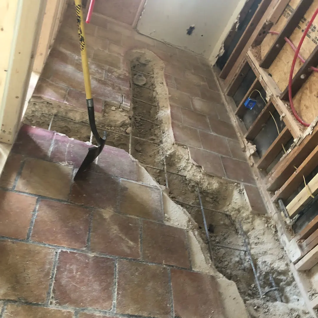 a brick floor with a mop on top of it