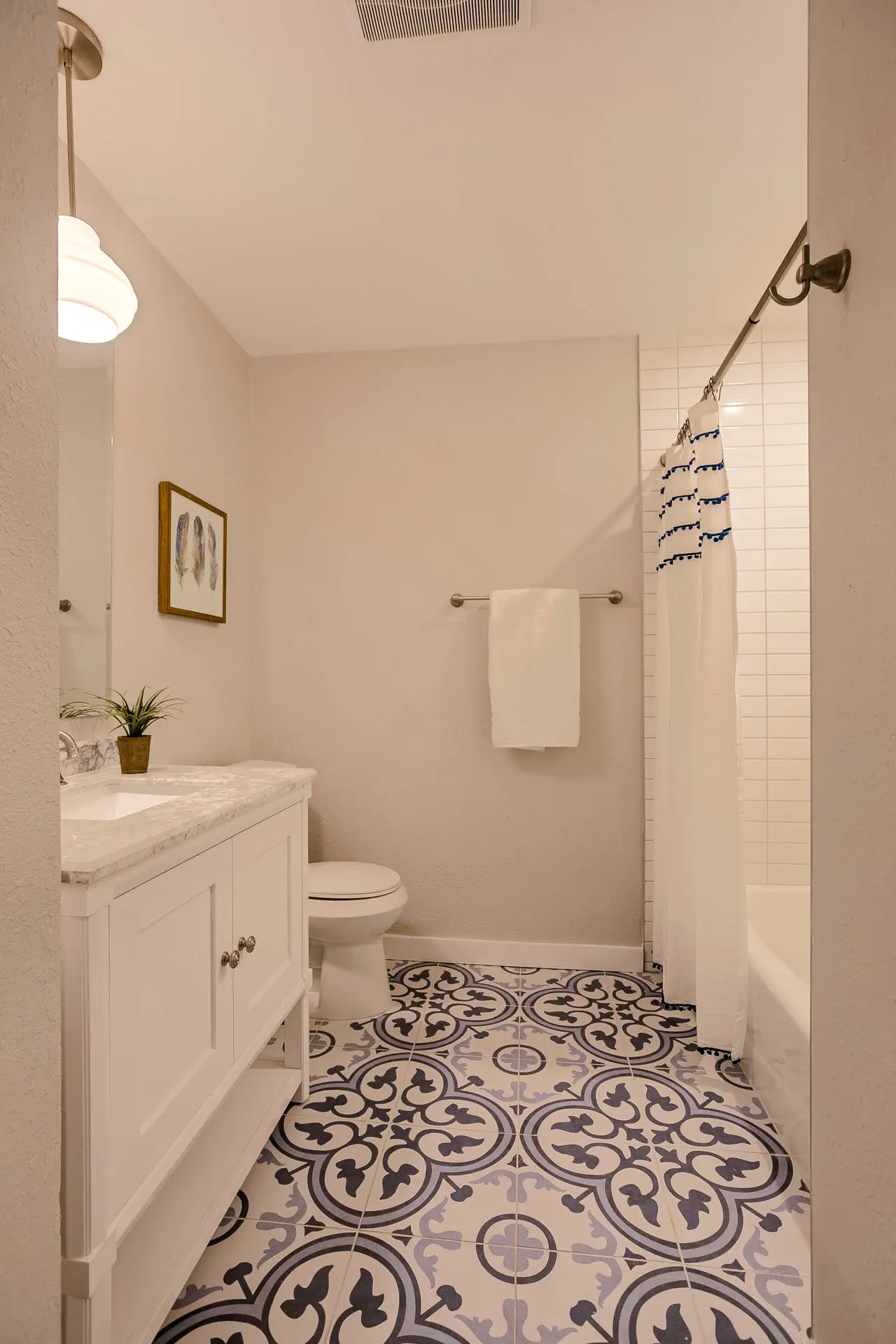 a bathroom with a blue and white tile floor