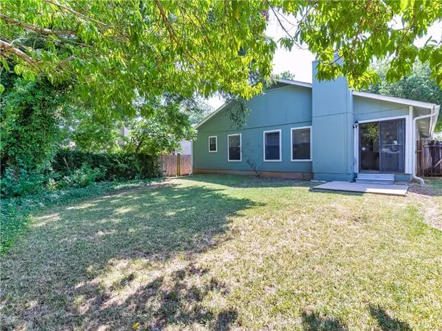 a blue house with a fence in front of it