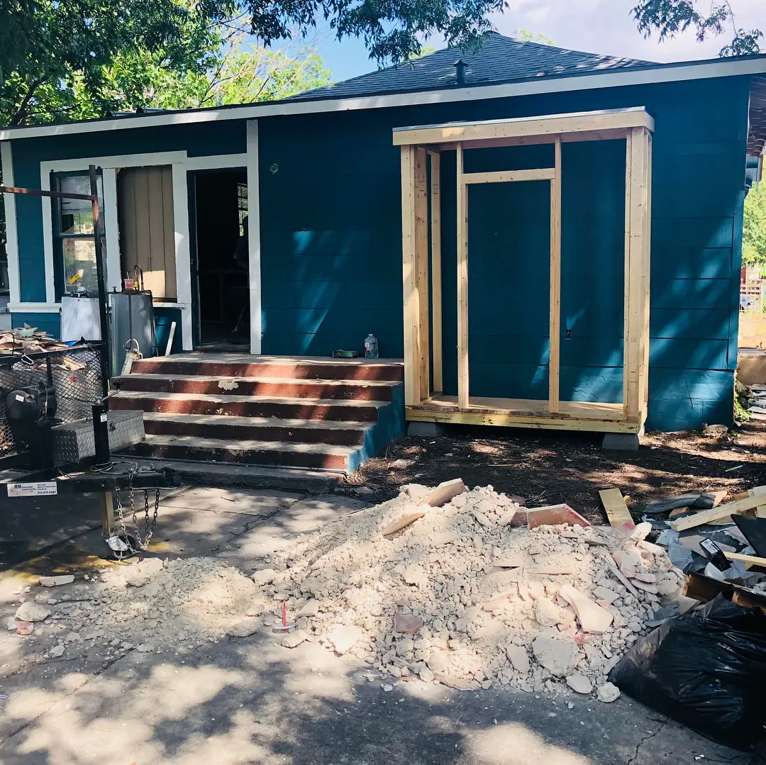 a small blue house with steps leading to it