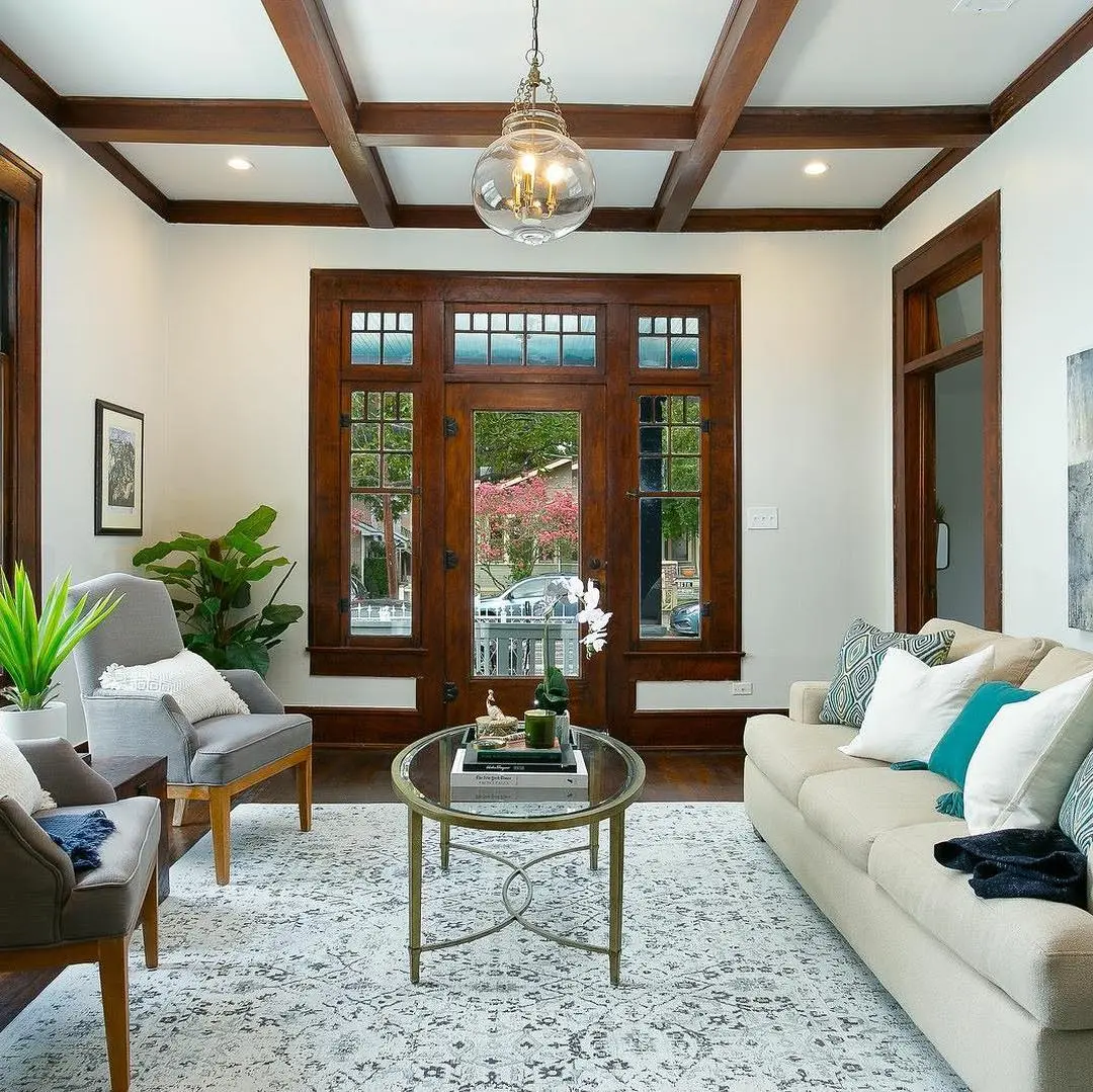 a living room filled with furniture and a large window
