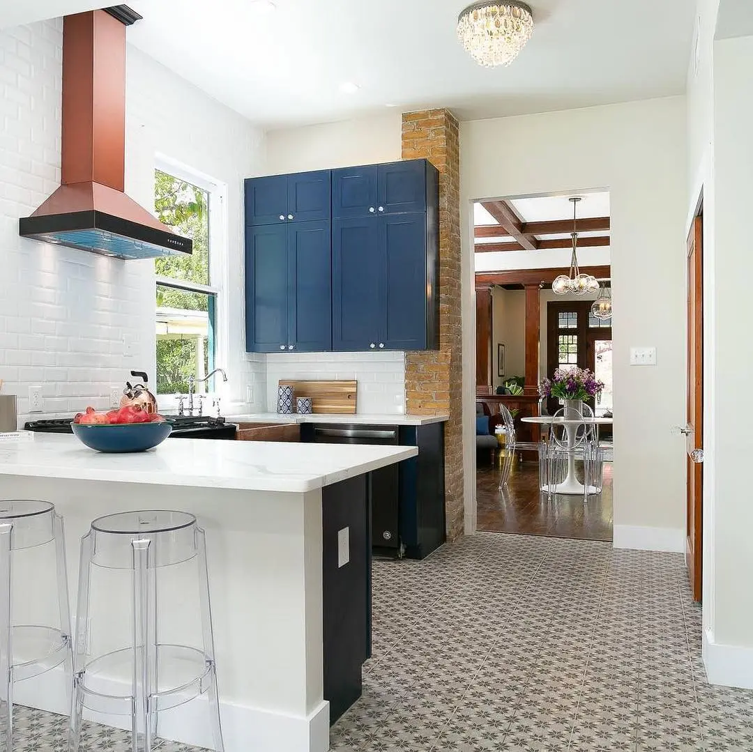 a kitchen with a center island and blue cabinets