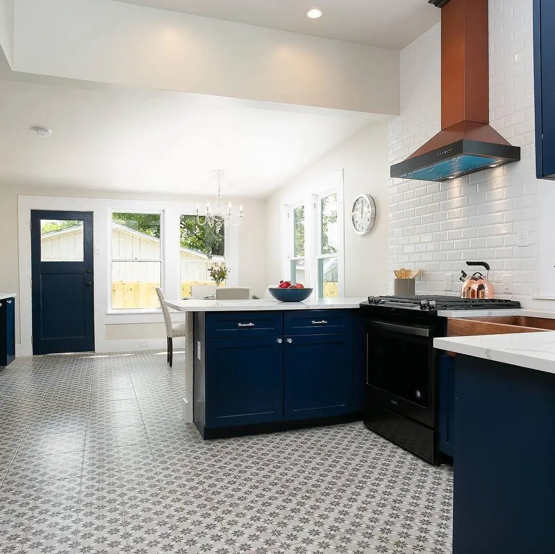 a kitchen with blue cabinets and a white tiled floor