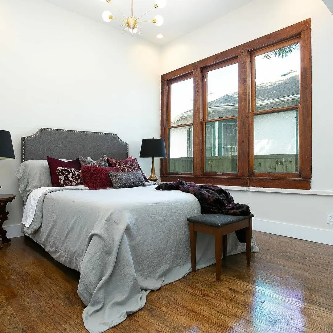 a bedroom with hardwood floors and a large bed