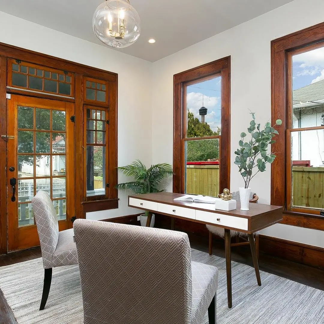 a living room filled with furniture and windows
