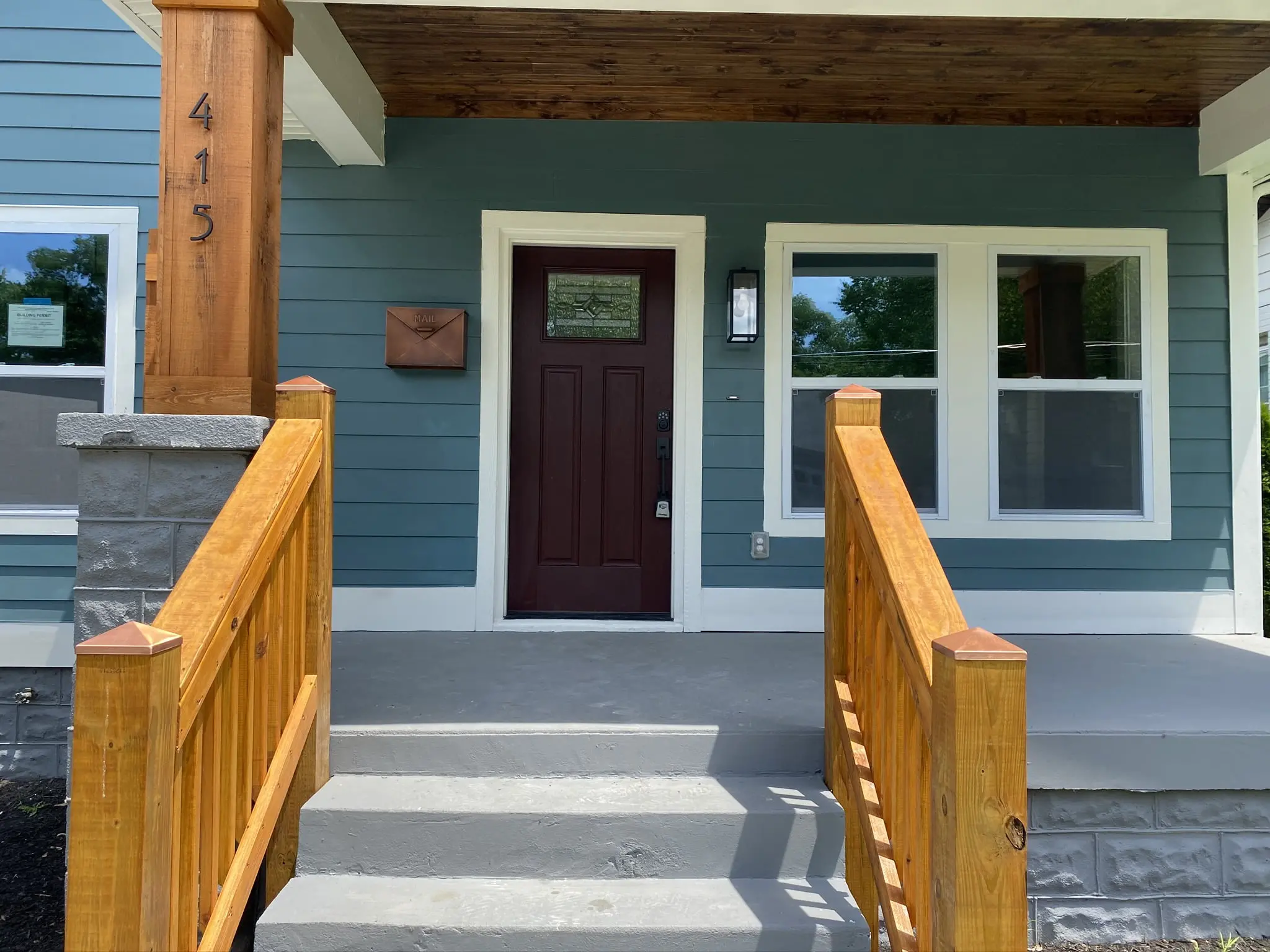a blue house with a brown front door