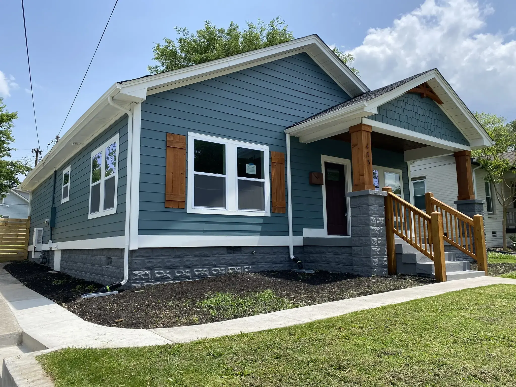 a small blue house with brown shutters