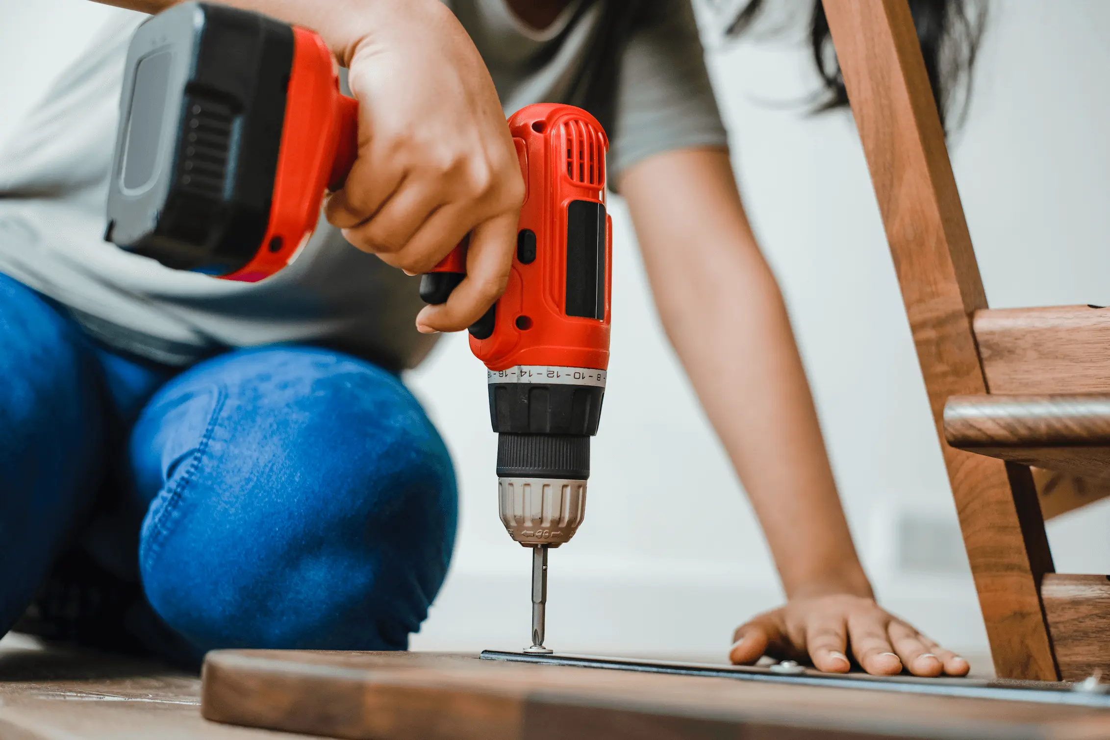 a person is using a drill to drill a hole in a piece of wood