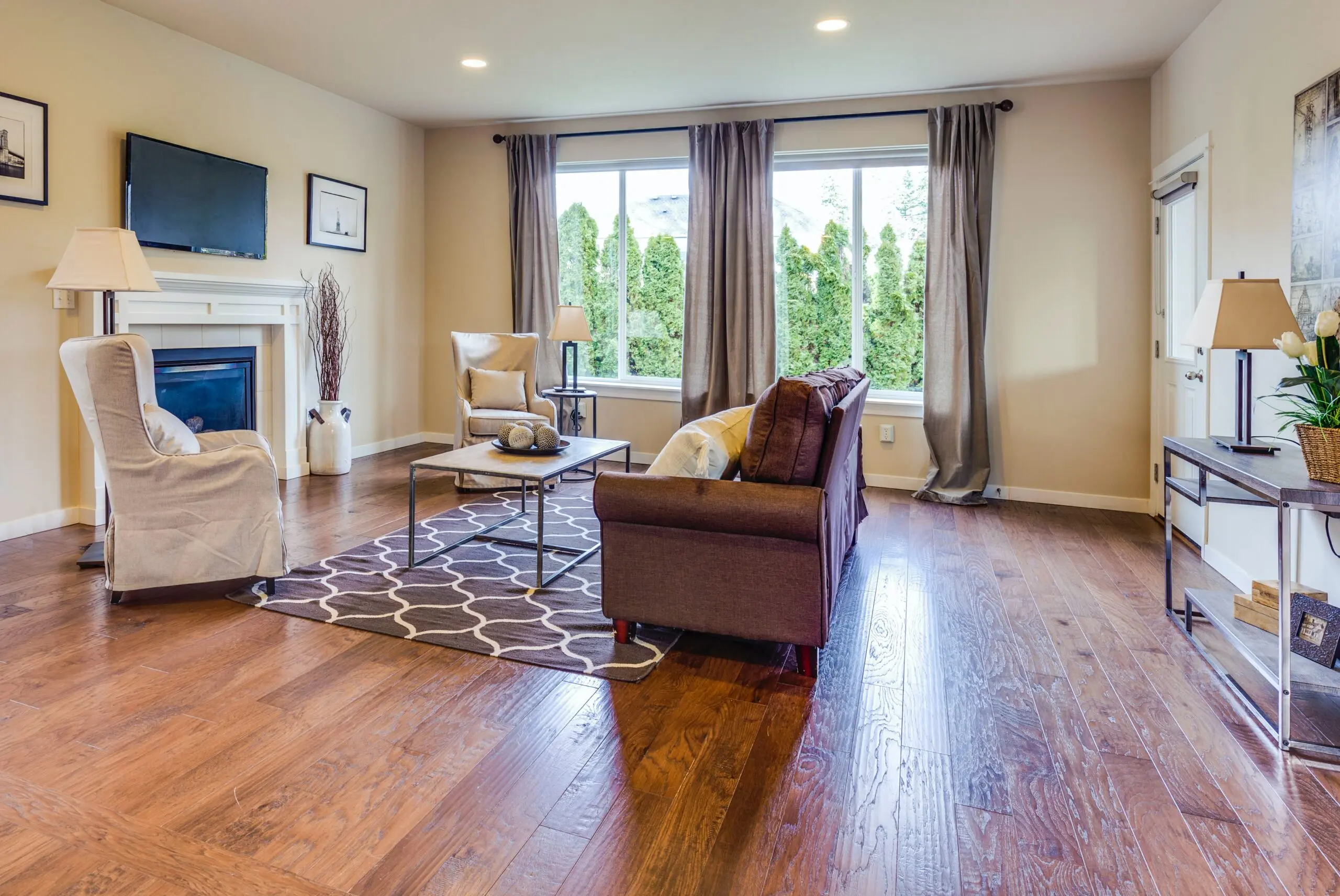 a living room with a fireplace and a flat screen tv