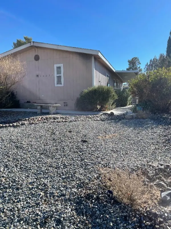 a house with a gravel driveway in front of it