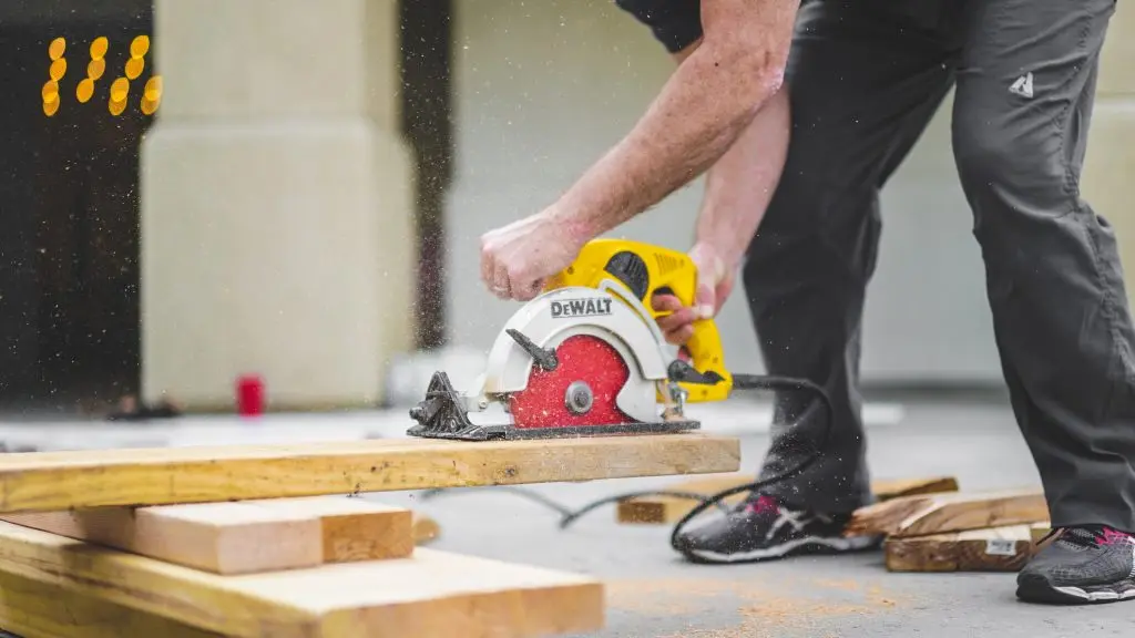 a man is using a dewalt circular saw to cut a piece of wood