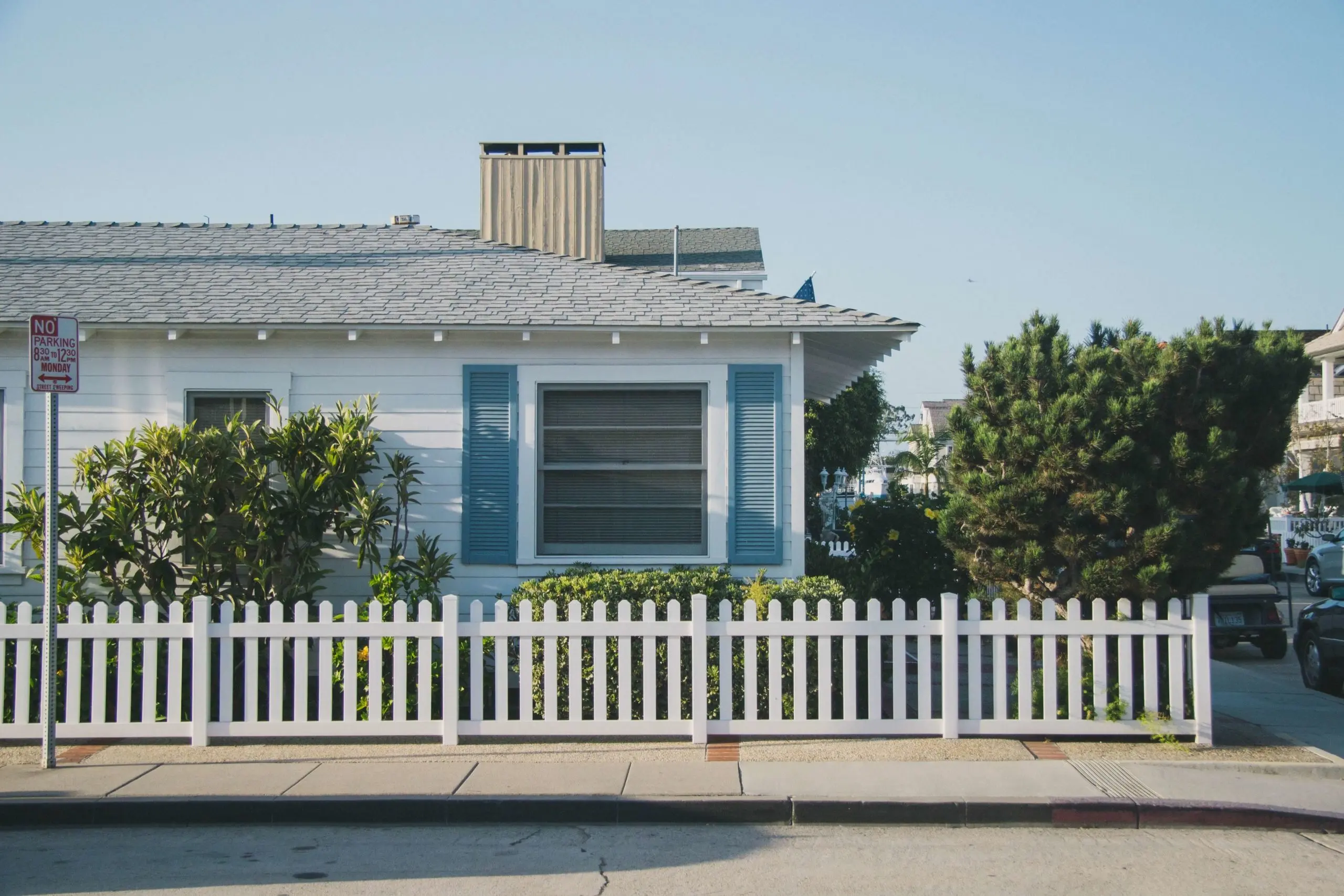 a white picket fence in front of a house