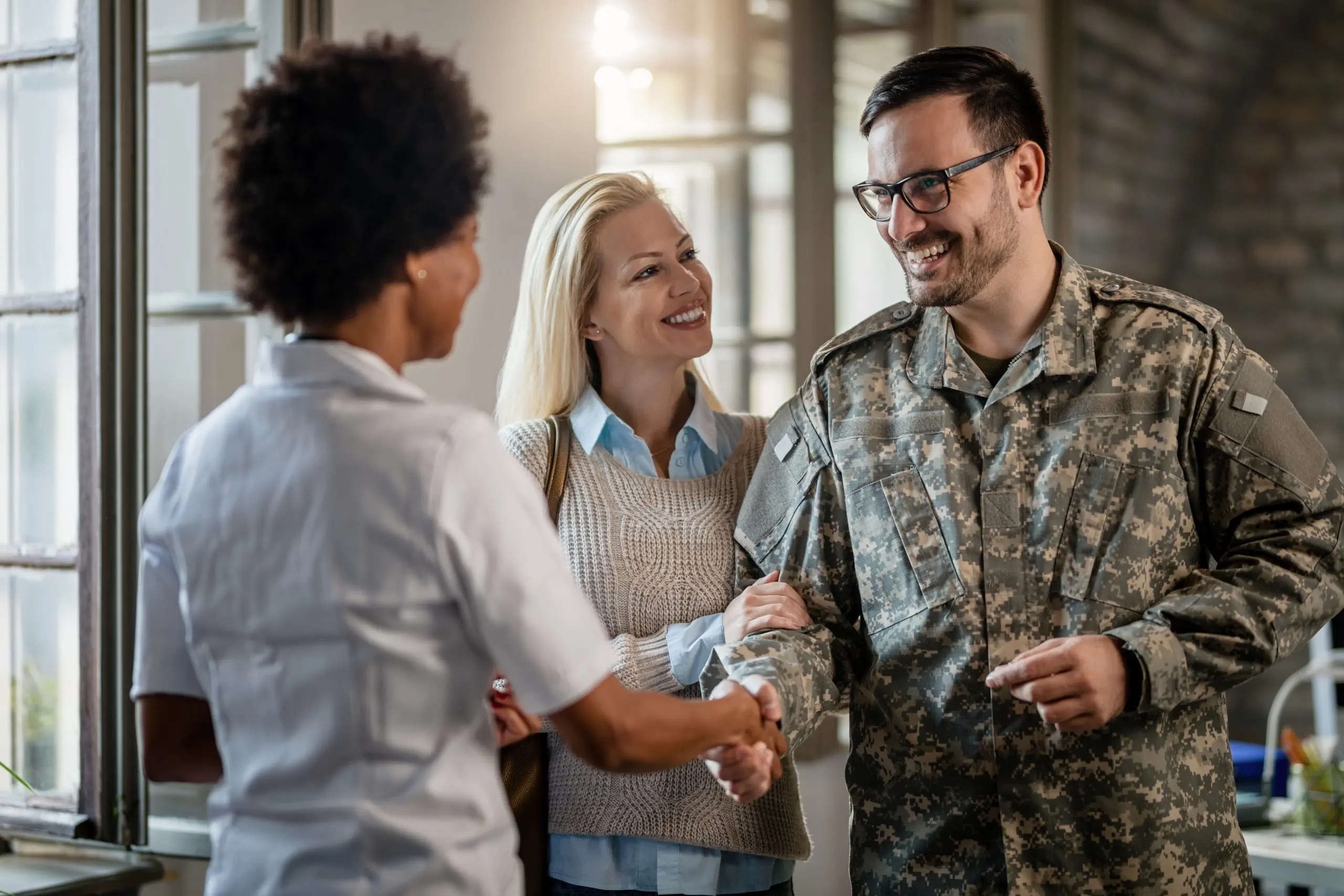 https://www.newwestern.com/wp-content/uploads/2023/10/happy-veteran-and-his-wife-greeting-african-americ-2022-09-30-17-03-09-utc-scaled.jpg
