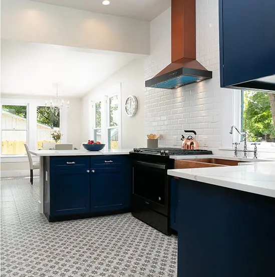 a kitchen with blue cabinets and a white tiled floor