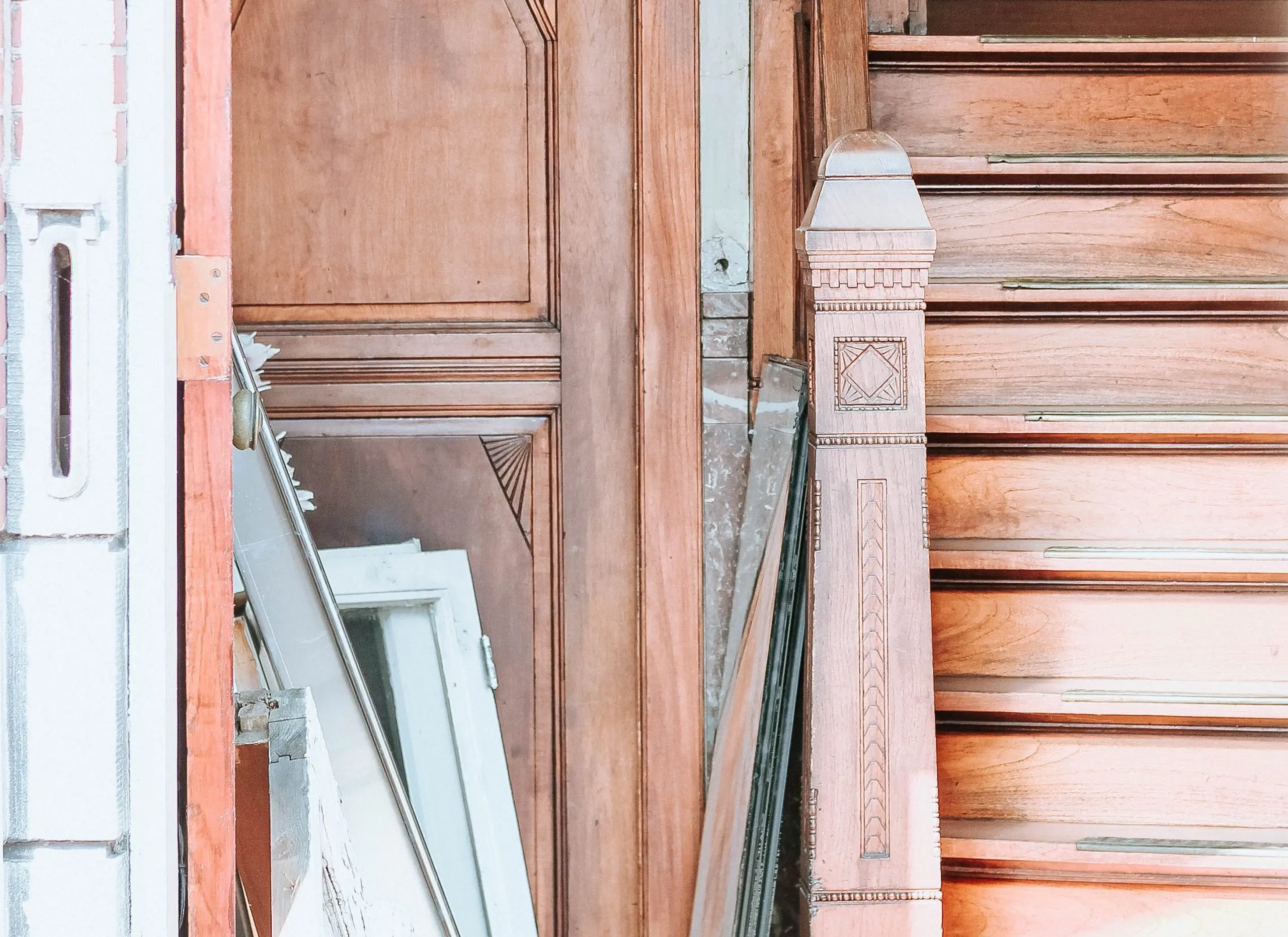 a staircase with a wooden railing and a wooden door