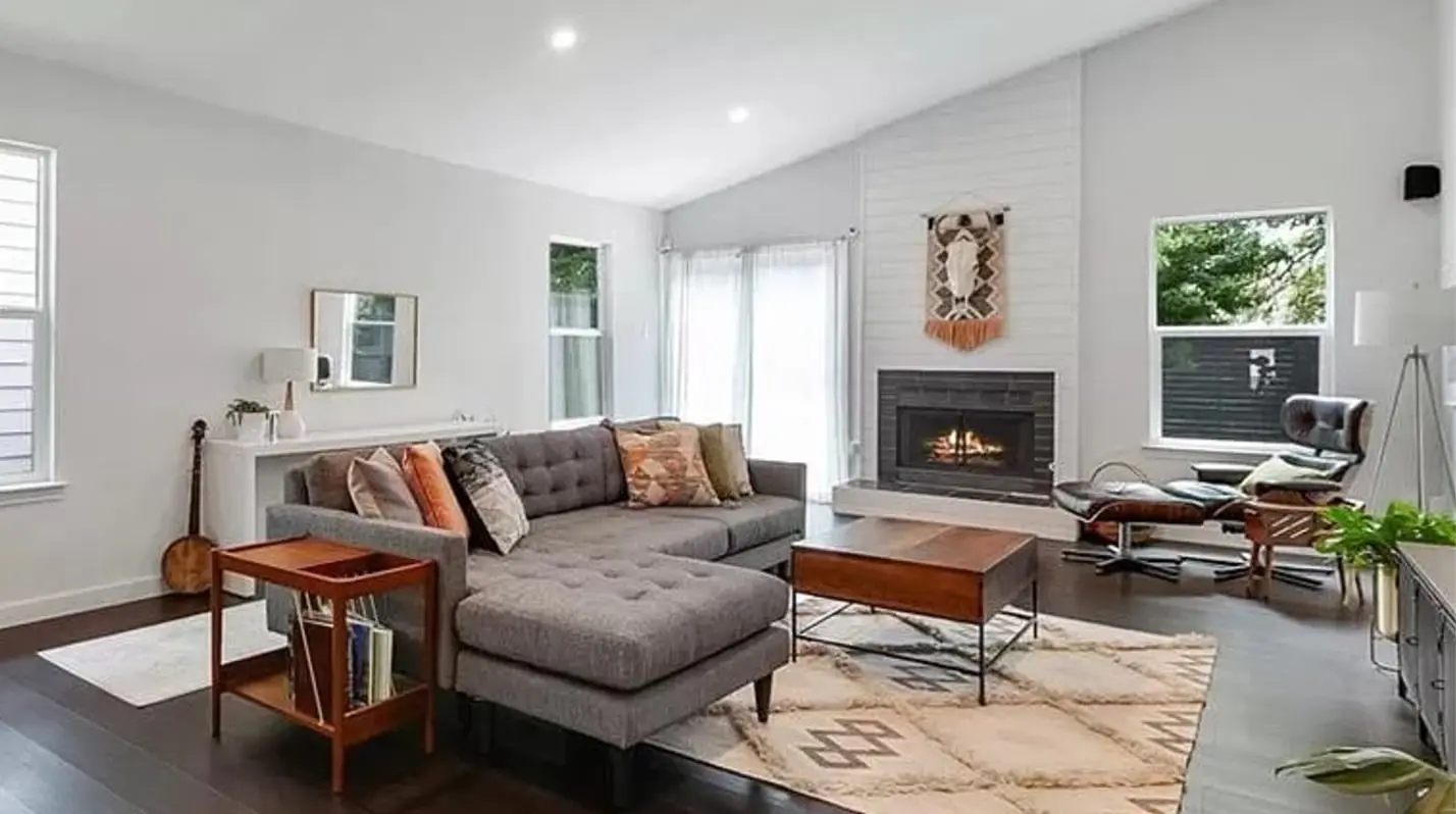 a living room filled with furniture and a fire place