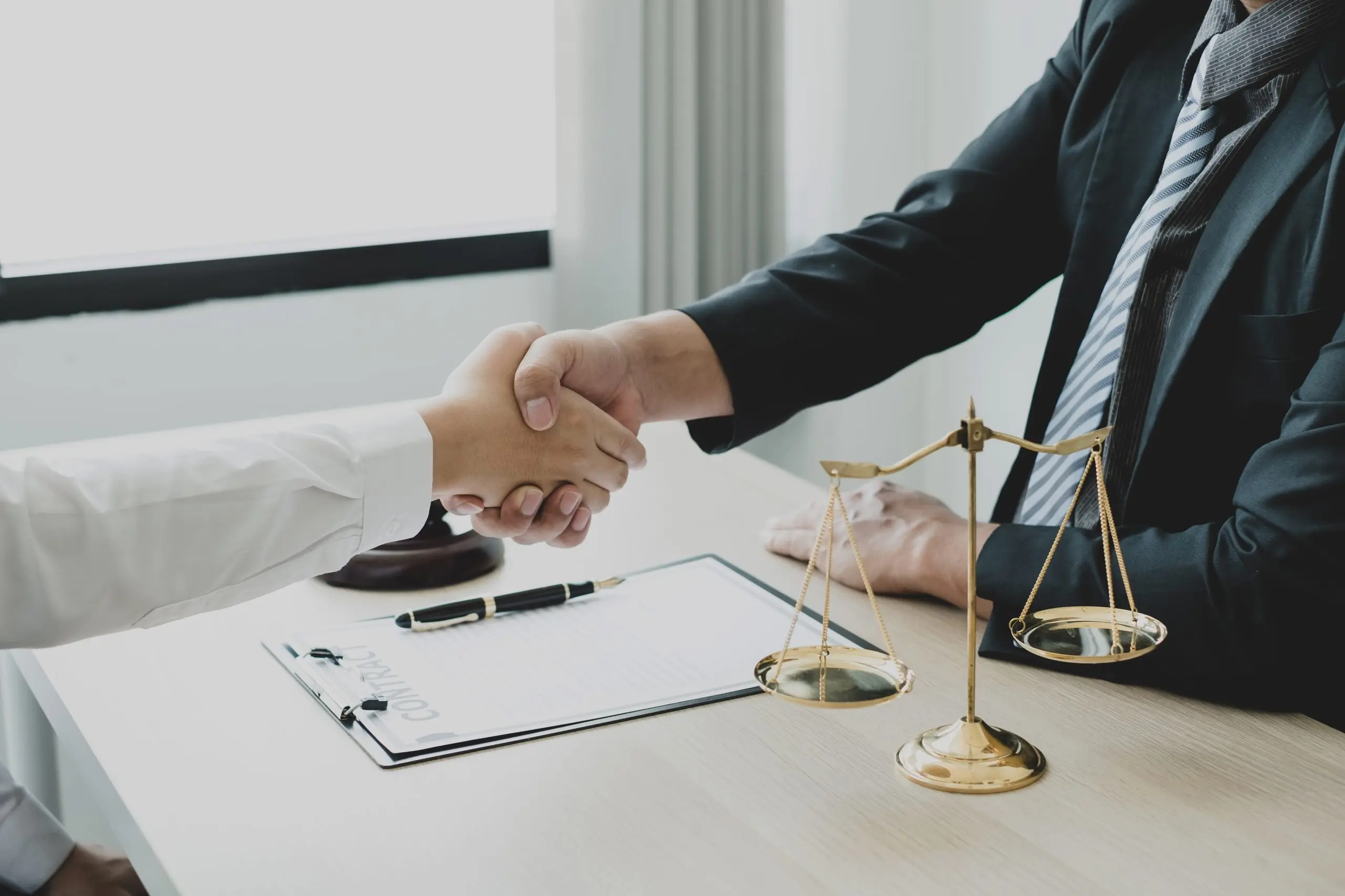 https://www.newwestern.com/wp-content/uploads/2023/10/shake-hand-professional-man-lawyers-work-at-a-law-2022-09-23-23-53-58-utc-scaled.jpg