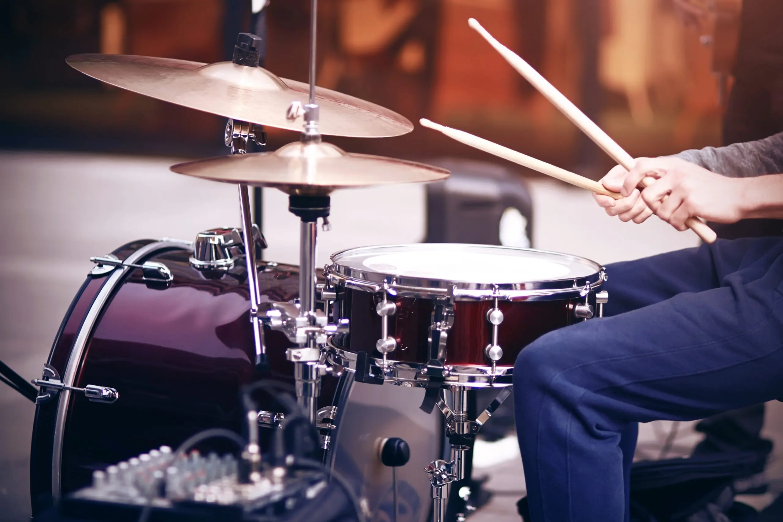 a person is playing a drum set with a yamaha drum set in the background