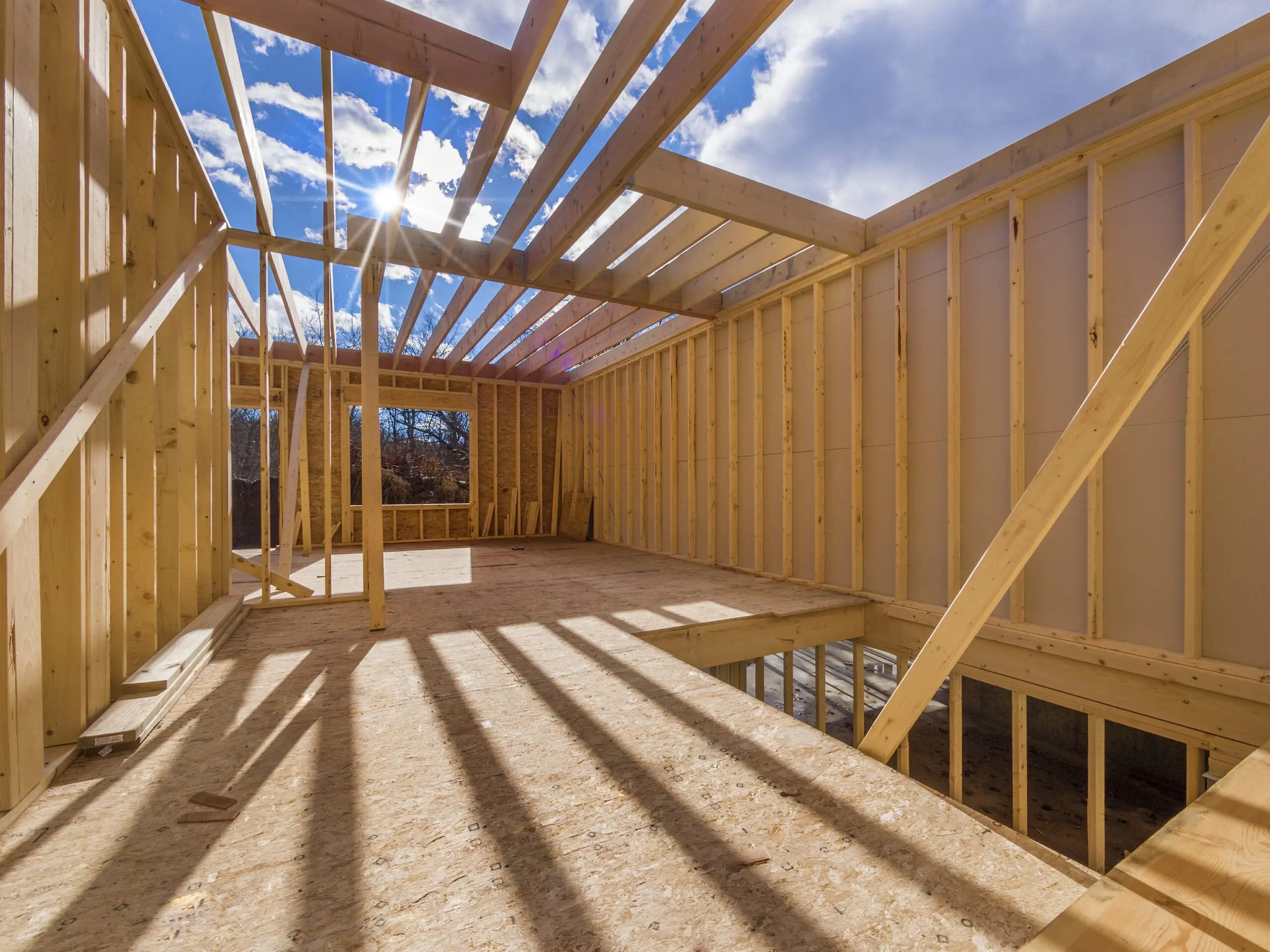 the sun is shining through the ceiling of a house under construction