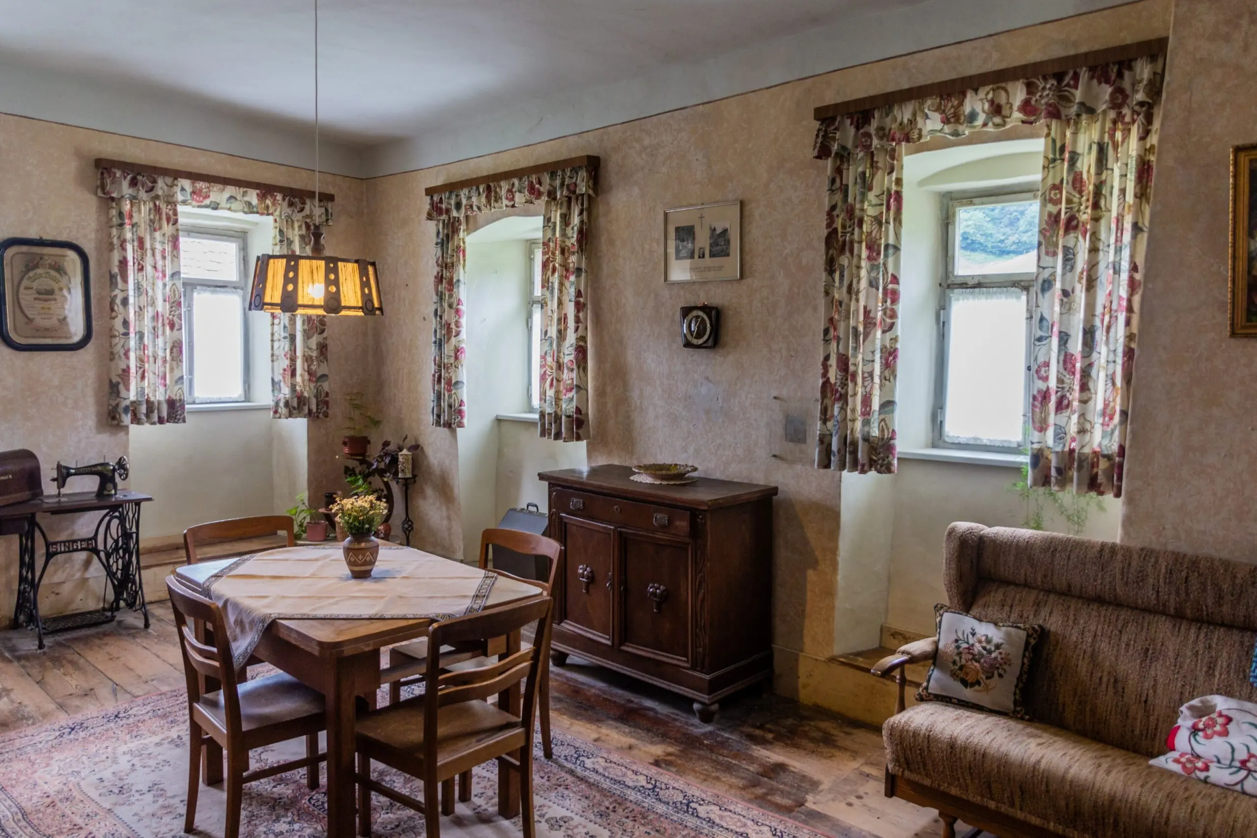 a living room with a table and chairs and a sewing machine