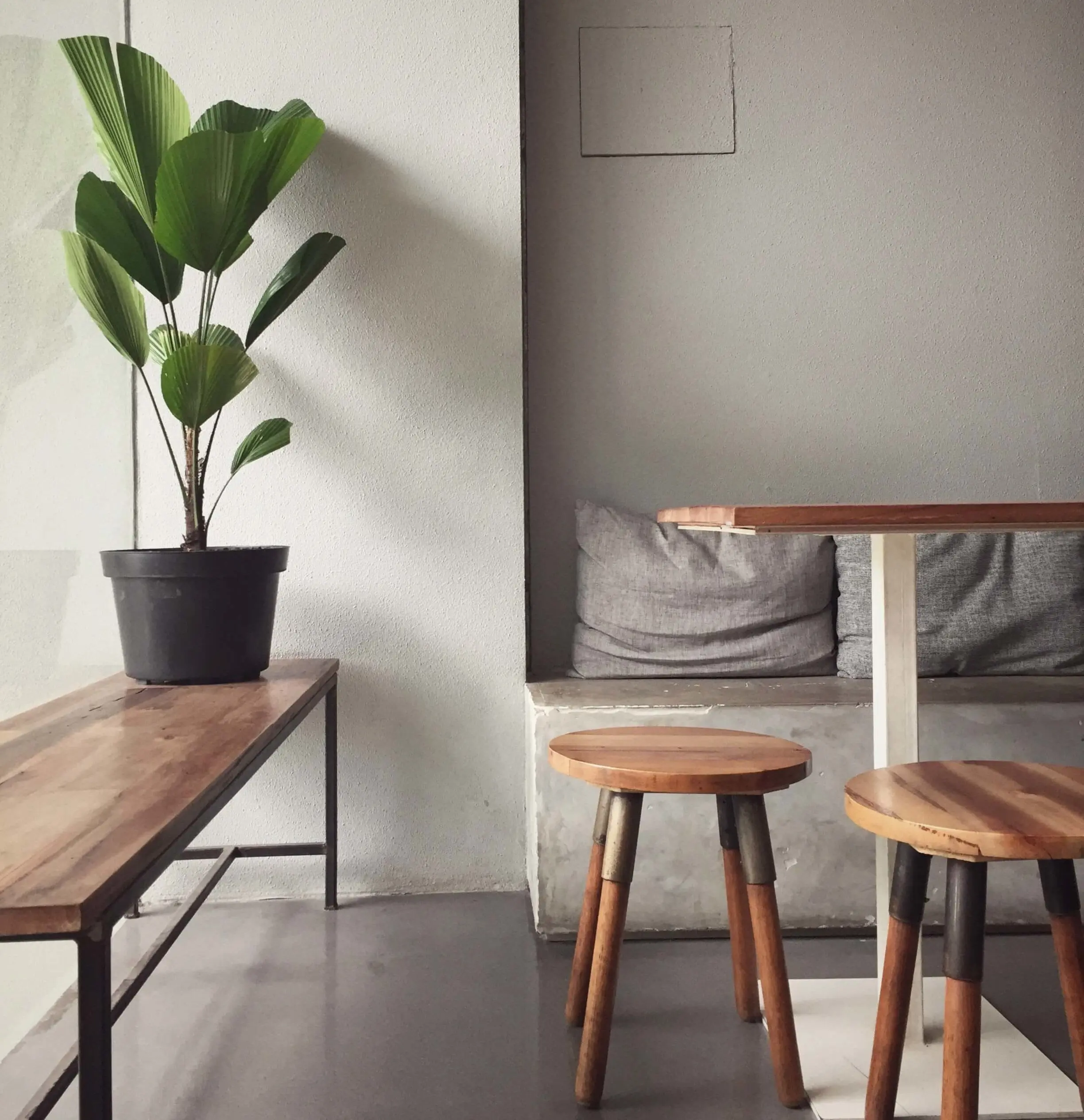 a living room with two stools and a table