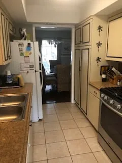 a kitchen with a stove, refrigerator and sink