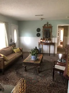a living room filled with furniture and a mirror