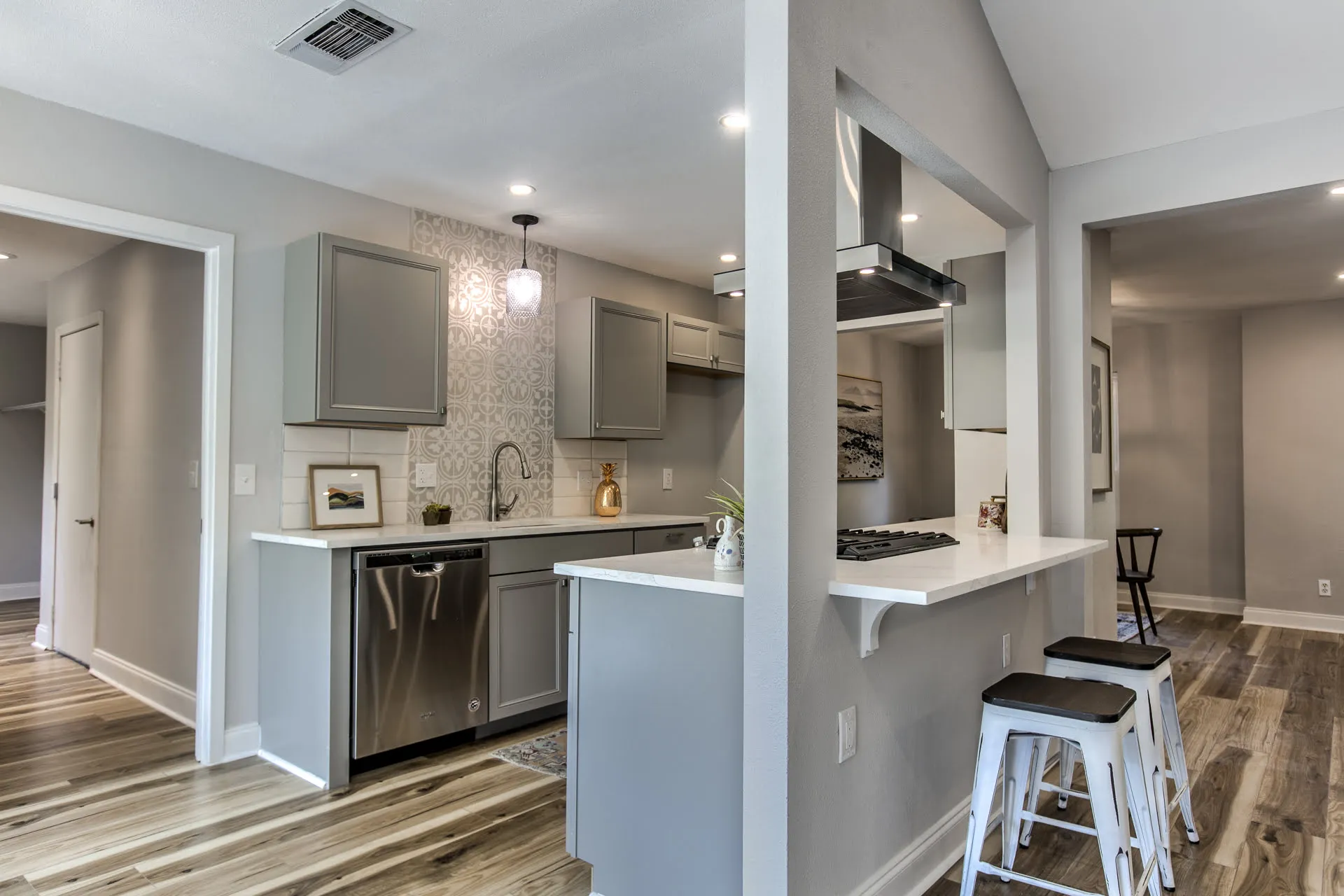 a kitchen and living room with hardwood floors
