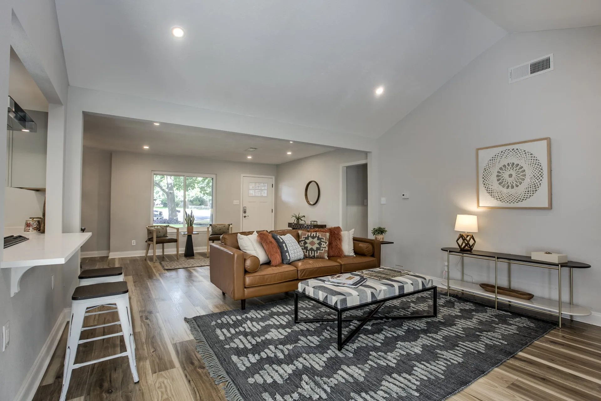 a living room filled with furniture and a large window