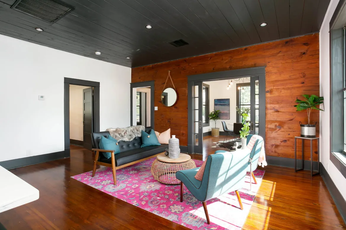 a living room filled with furniture and a large window
