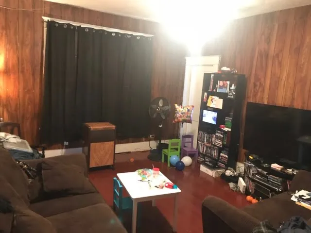 a living room filled with furniture and a flat screen tv