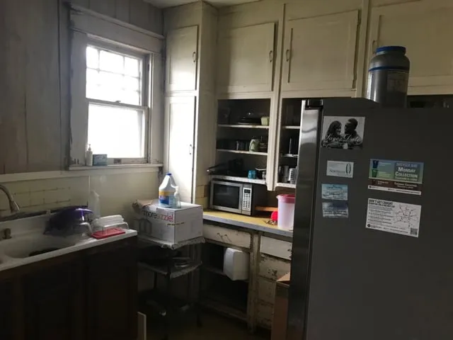 a kitchen with a refrigerator and a sink