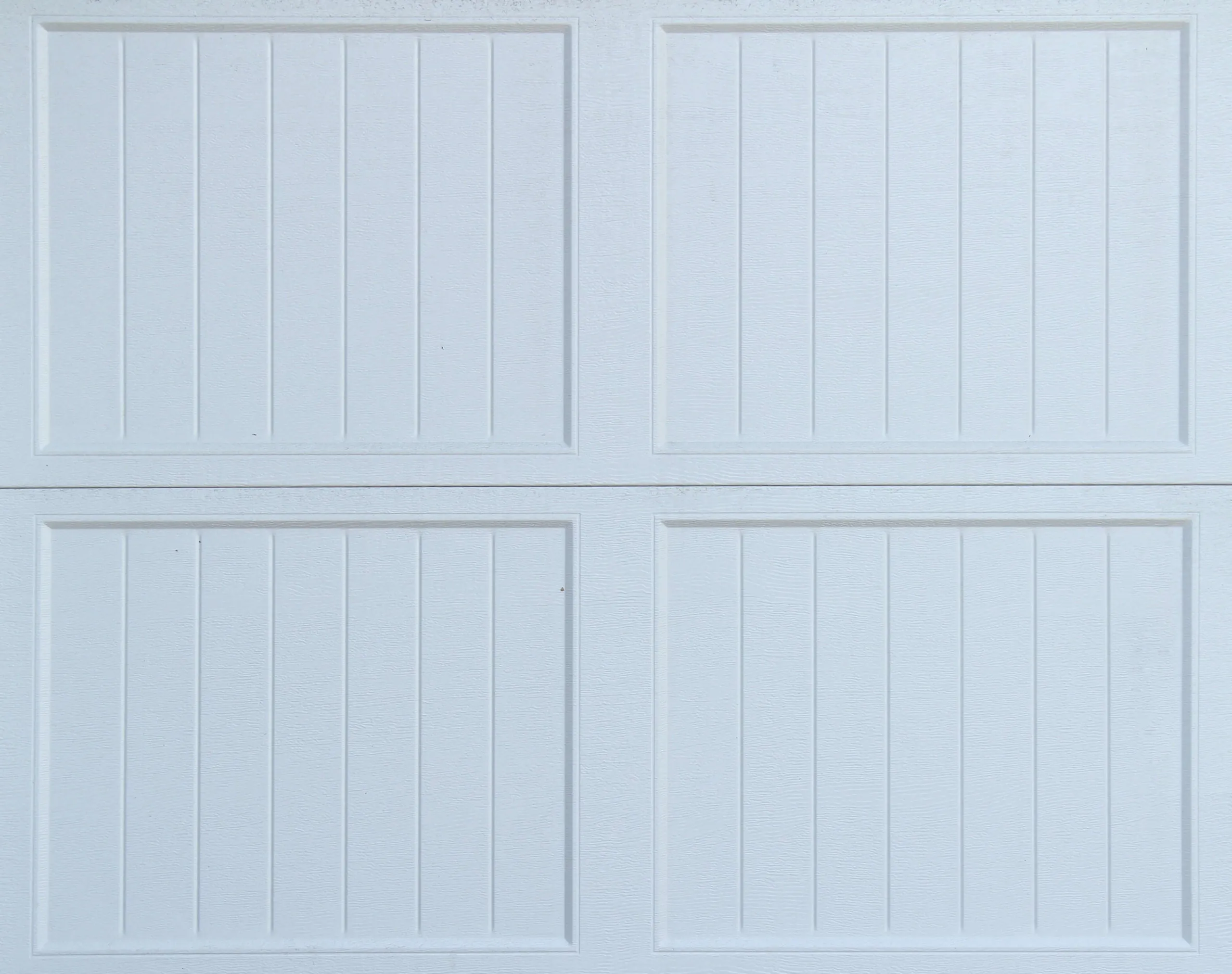 a white garage door with four panels on it