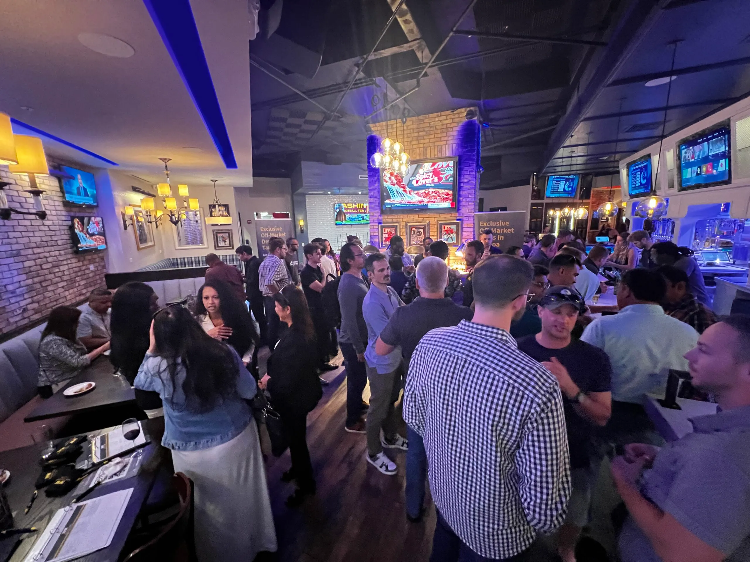 a group of people standing around a bar