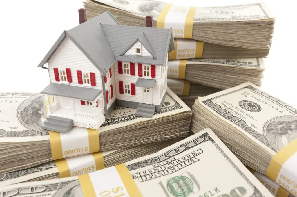 small-house-with-stacks-of-hundred-dollar-bills