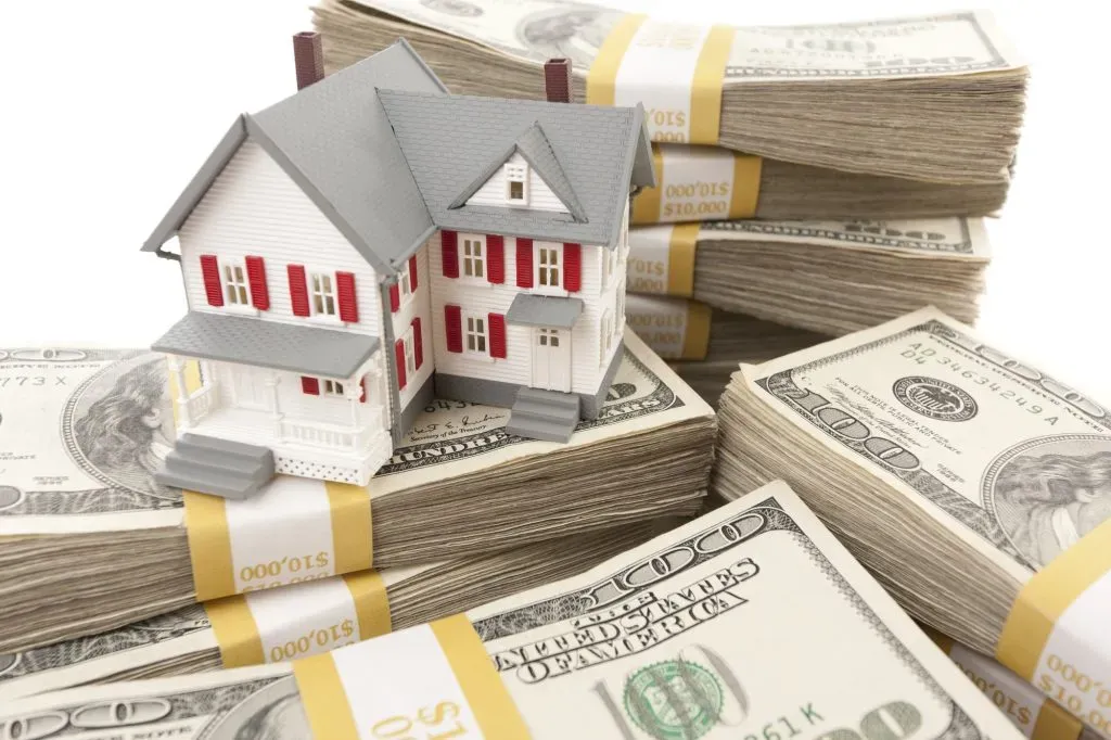 small-house-with-stacks-of-hundred-dollar-bills