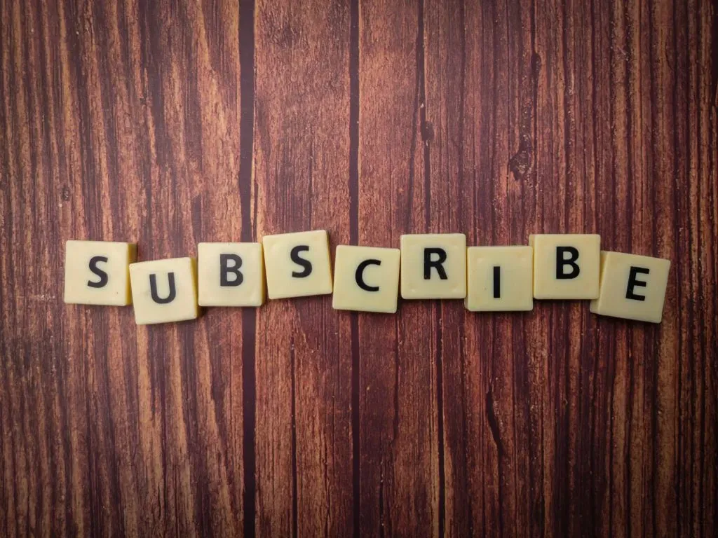 toys-word-arranged-on-a-wooden-background-with-the-word-subscribe